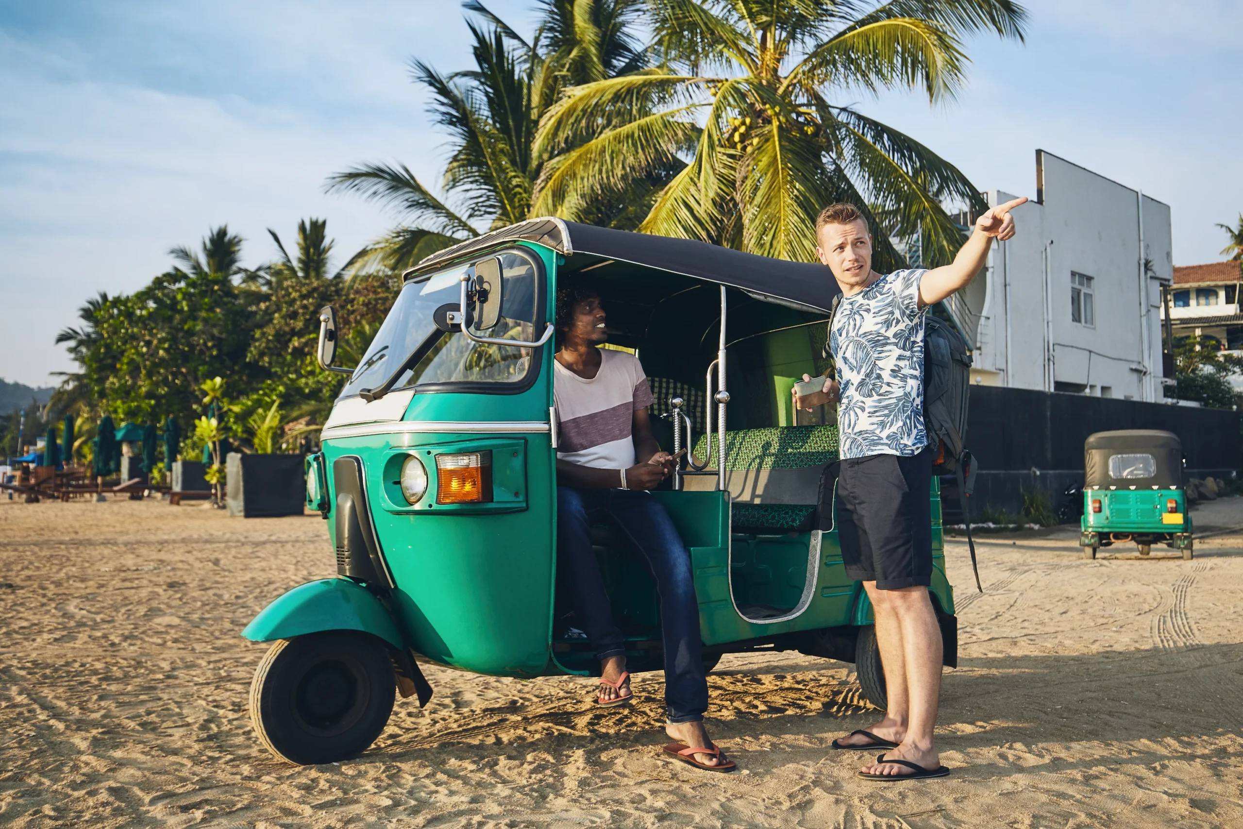 men talking by rickshaw beach 2 scaled